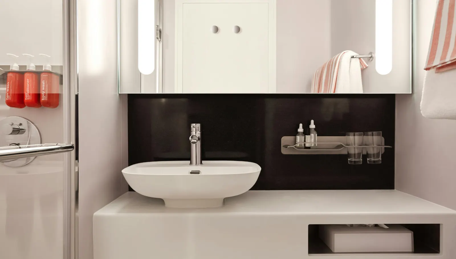 Cabin bathroom sink and mirror on a Virgin Voyages ship