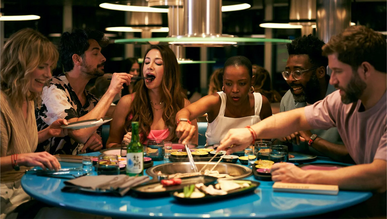 Diners sharing a Korean grill table at an onboard restaurant