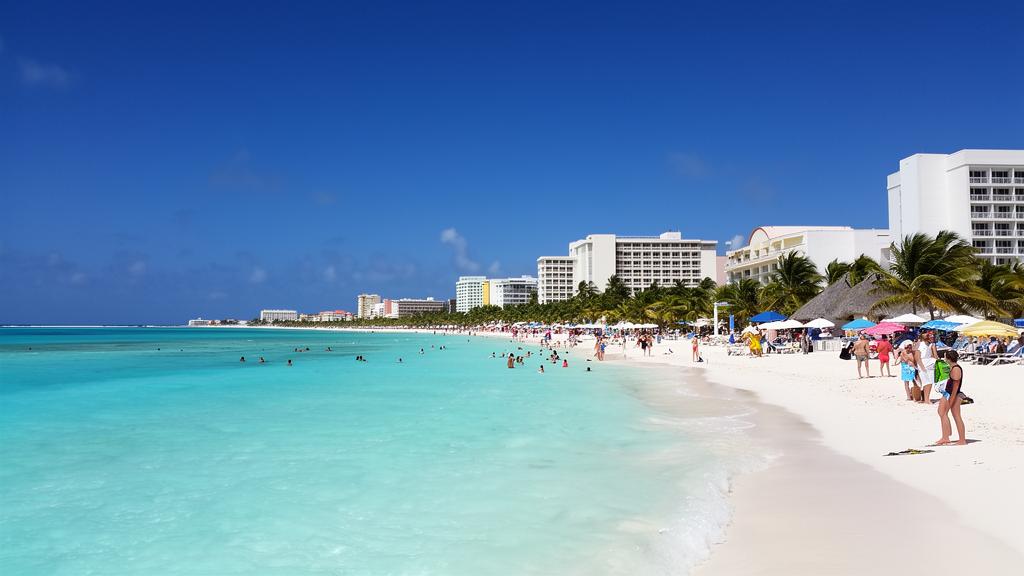 Cancun beachfront with turquoise Caribbean water and people enjoying the beach